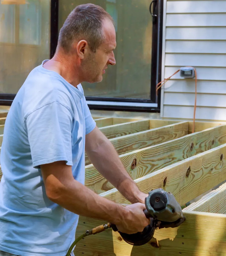 Deck framing contractor building an outdoor wood deck structure for a residential property in Dallas, Texas