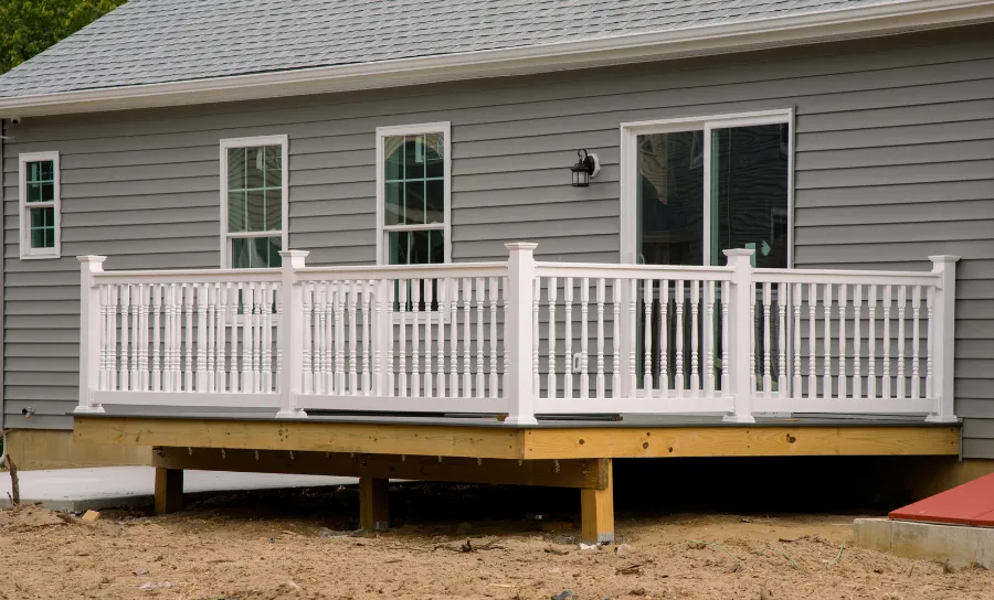Residential backyard deck construction project showing elevated platform and support framing