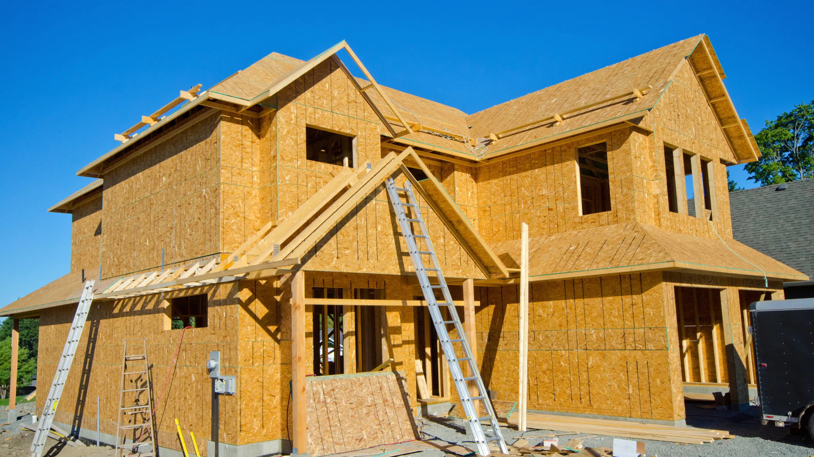 Residential home framing stage in Dallas showing exposed wood framing before exterior finishes.